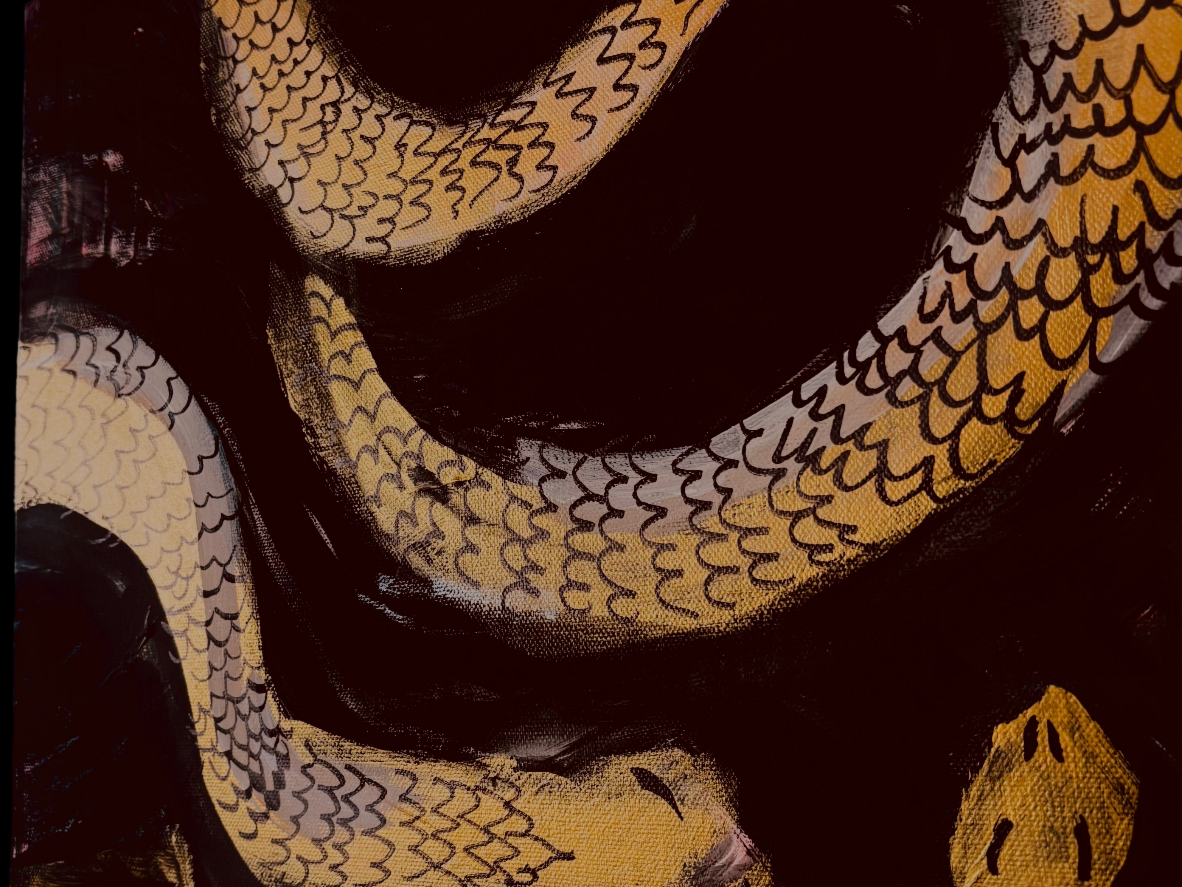 A closeup of a gold and black painting with snakes winding around each other, this is a closeup of "Medusa"